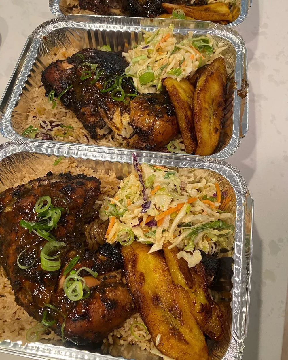 Jerk chicken plates with rice, slaw and sweet plantain
